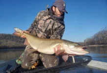 Hunting with a Fly #1 | Fly Fishing Like a Hunter with Joe Goodspeed Fly angler Joe Goodspeed holding a large muskie in a landing net while fishing from a boat.