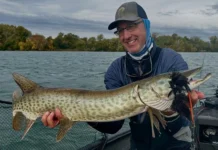 Hunting with a Fly #2 | Rick Kustich’s Musky Fly Fishing Playbook Rick Kustich holding a musky caught on a fly with a large streamer in its mouth