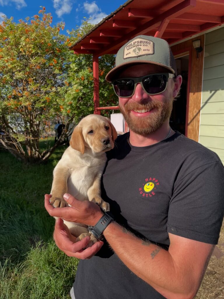 Drew Baker with his Brown Lab little pup Photo Provided by DrewBakerPhoto