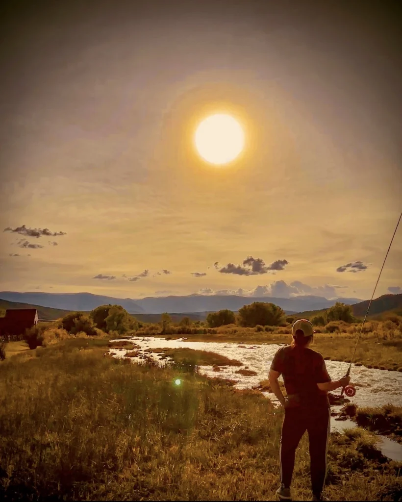angler fly fishing a small stream similar to the Mora River in New Mexico