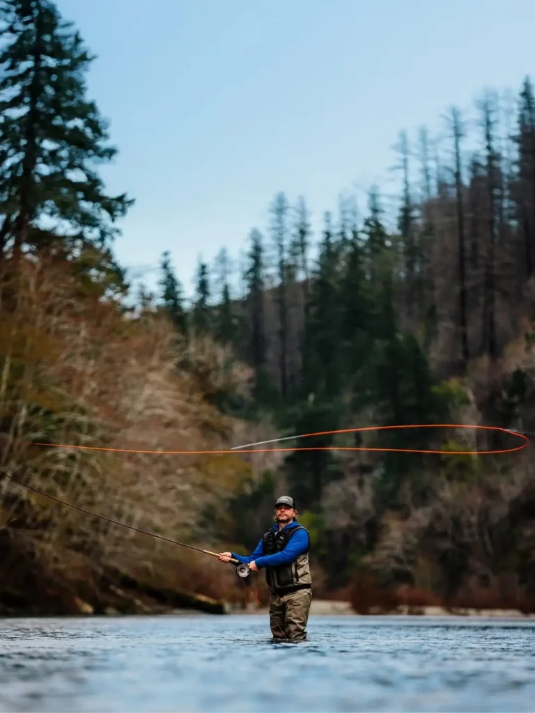 Angler Spey casting for winter steelhead on a Pacific Northwest river during cold water conditions.