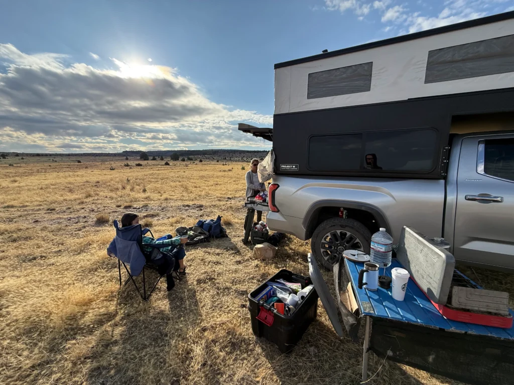 setting up camp next to truck camper during our road trip
