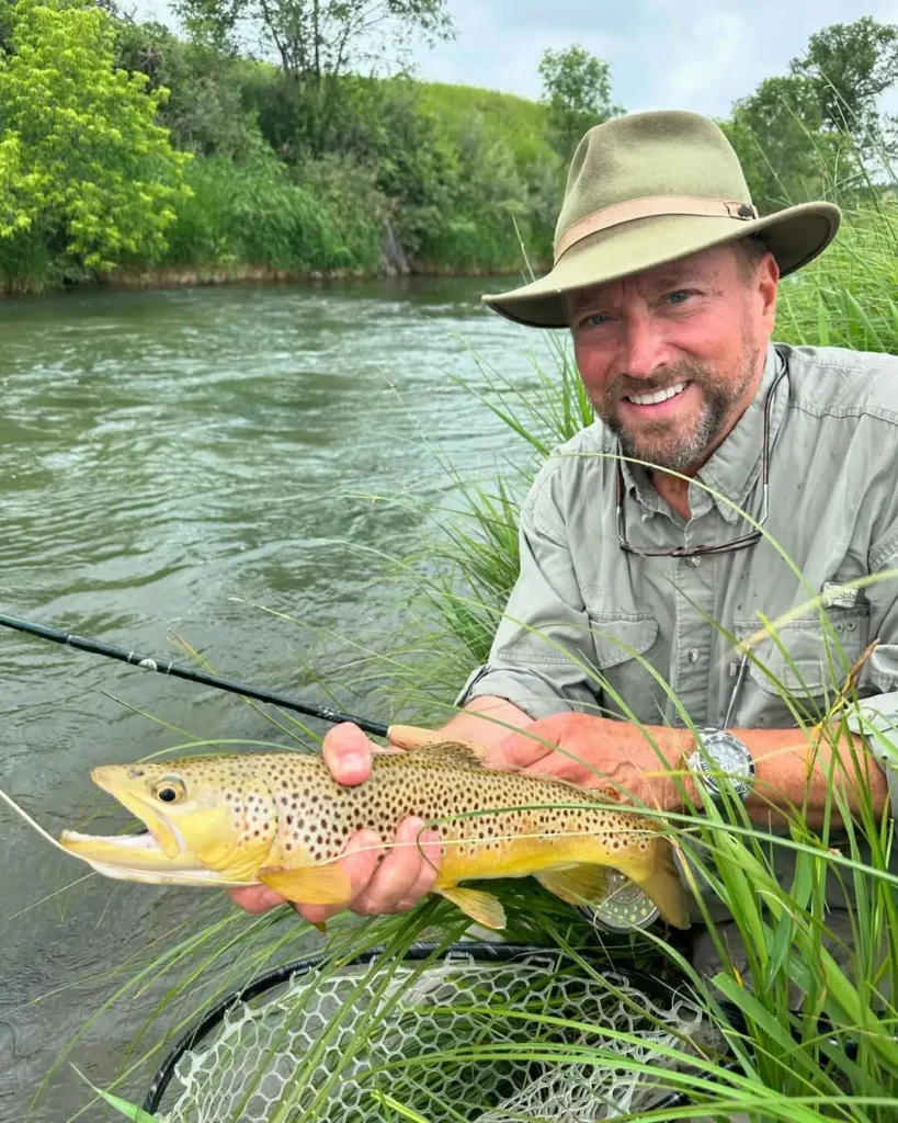 John Van Vliet holding brown trout driftless fly fishing stream