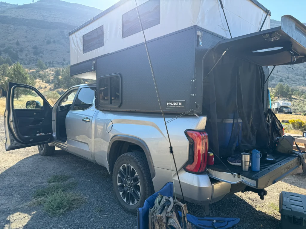Toyota Tundra with Four Wheel Camper Project M set up at campsite