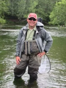 Fly angler standing in a river in Kamchatka during a remote fly fishing trip